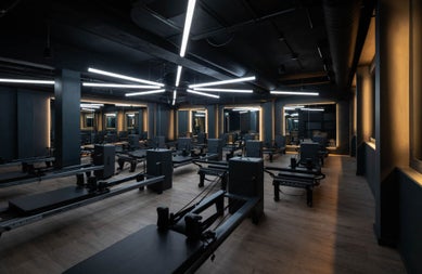 Spaced out exercise equipment and benches in a gym