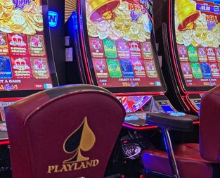 Playland Casino view of chairs in front of colourful digital gaming machines