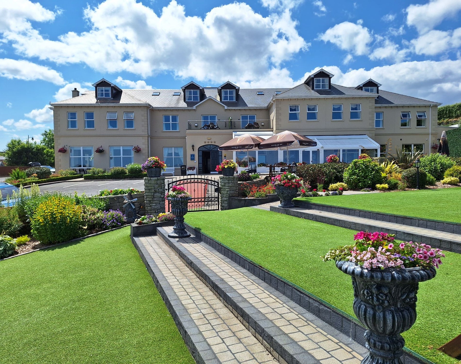 Ballyliffin Lodge hotel exterior with landscaped gardens and terrace seating
