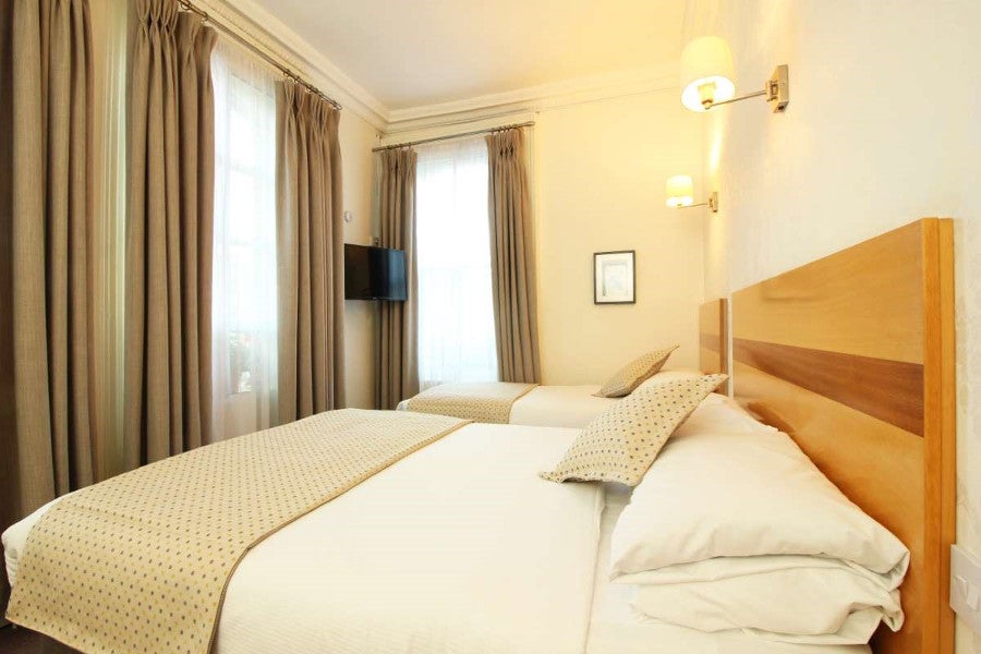 Double and single bed with white sheets