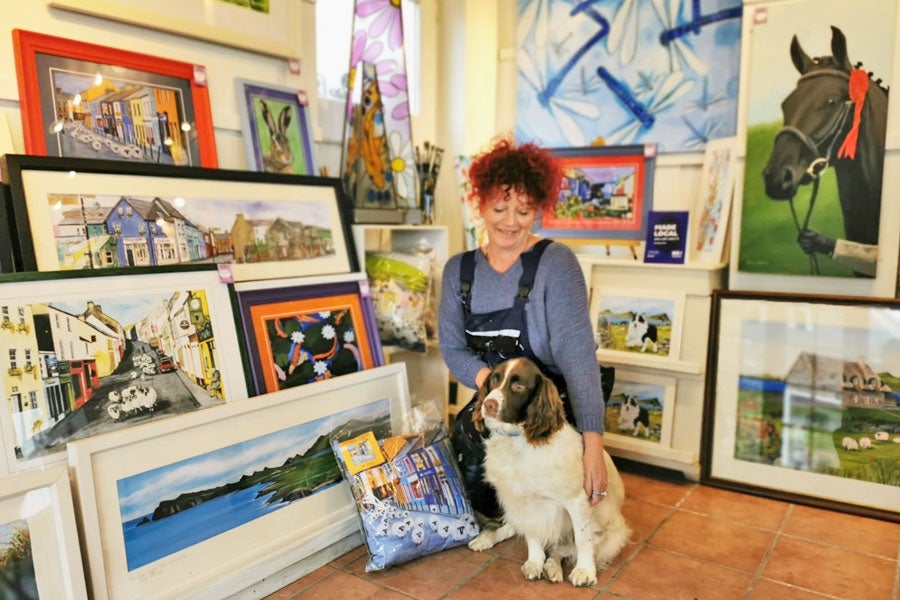 It Must Be Dingle Gallery interior of shop with paintings dog and owner