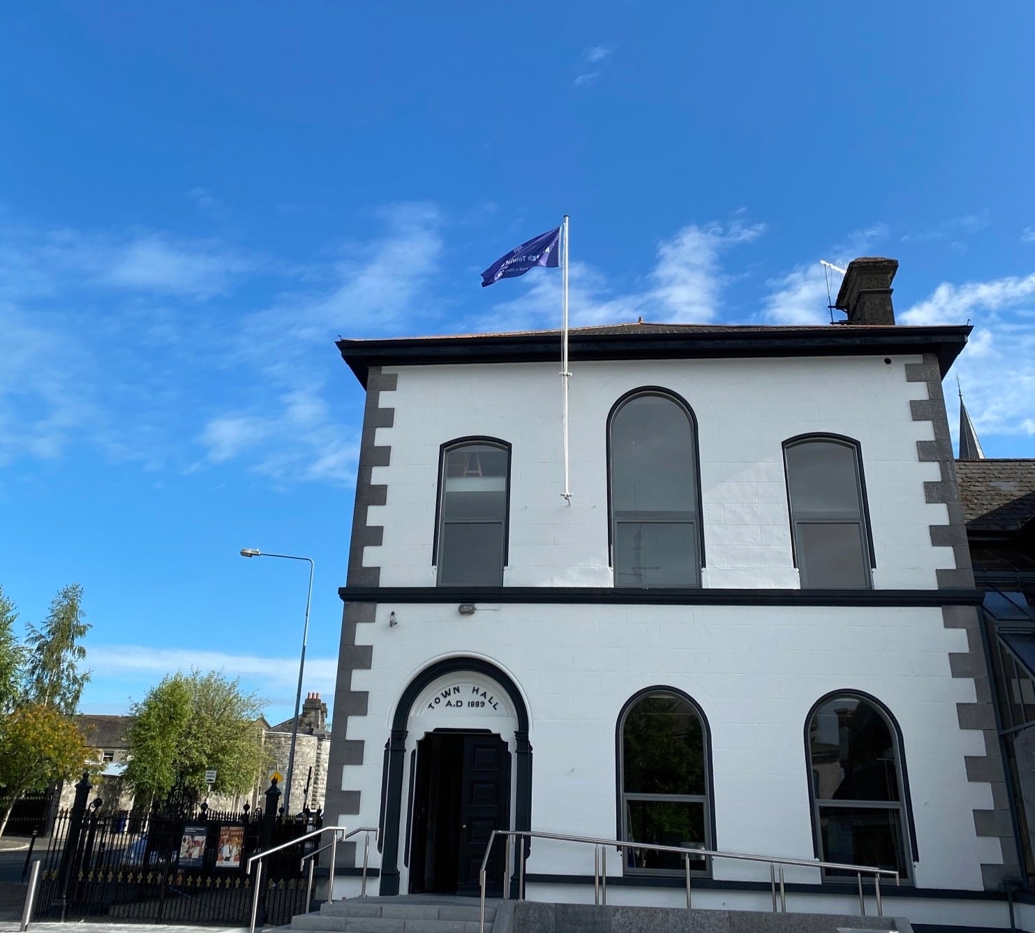 An image of the exterior of the black and white Town Hall where Nenagh Community Tourist Office is located inside