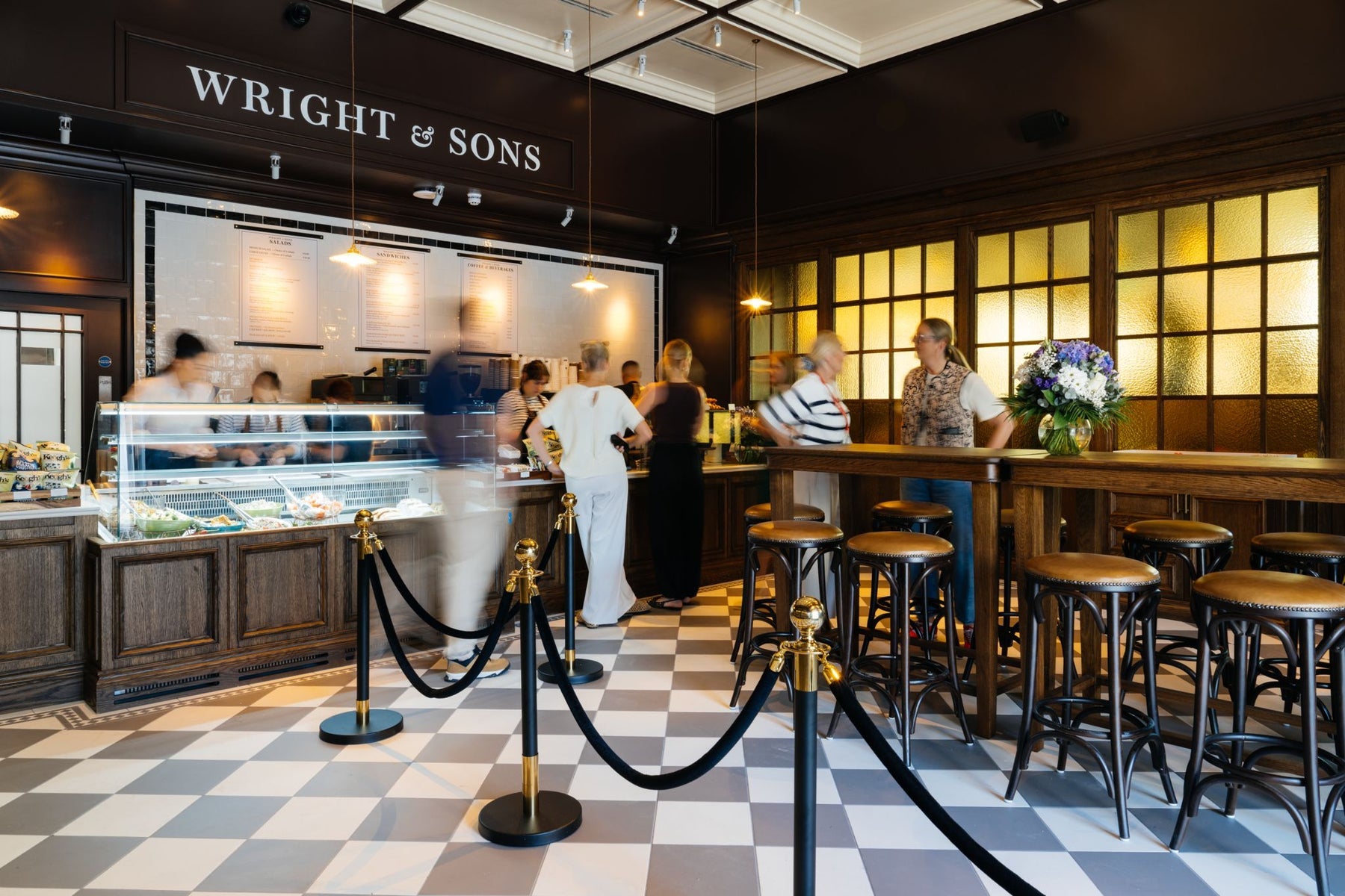 The interior of a bar with people queuing at the deli