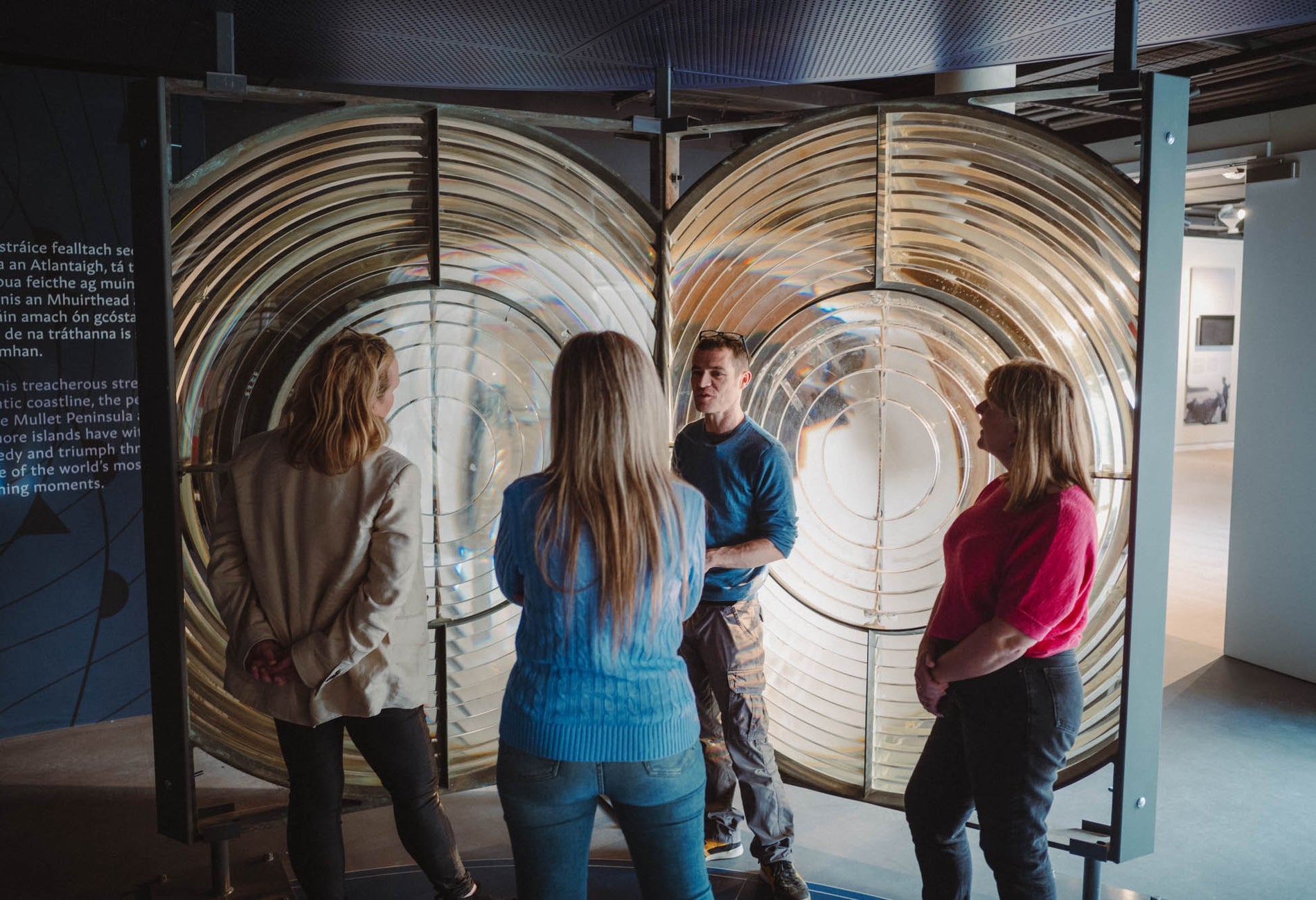 People standing and listening while on a guided tour around the Solas Visitor Centre