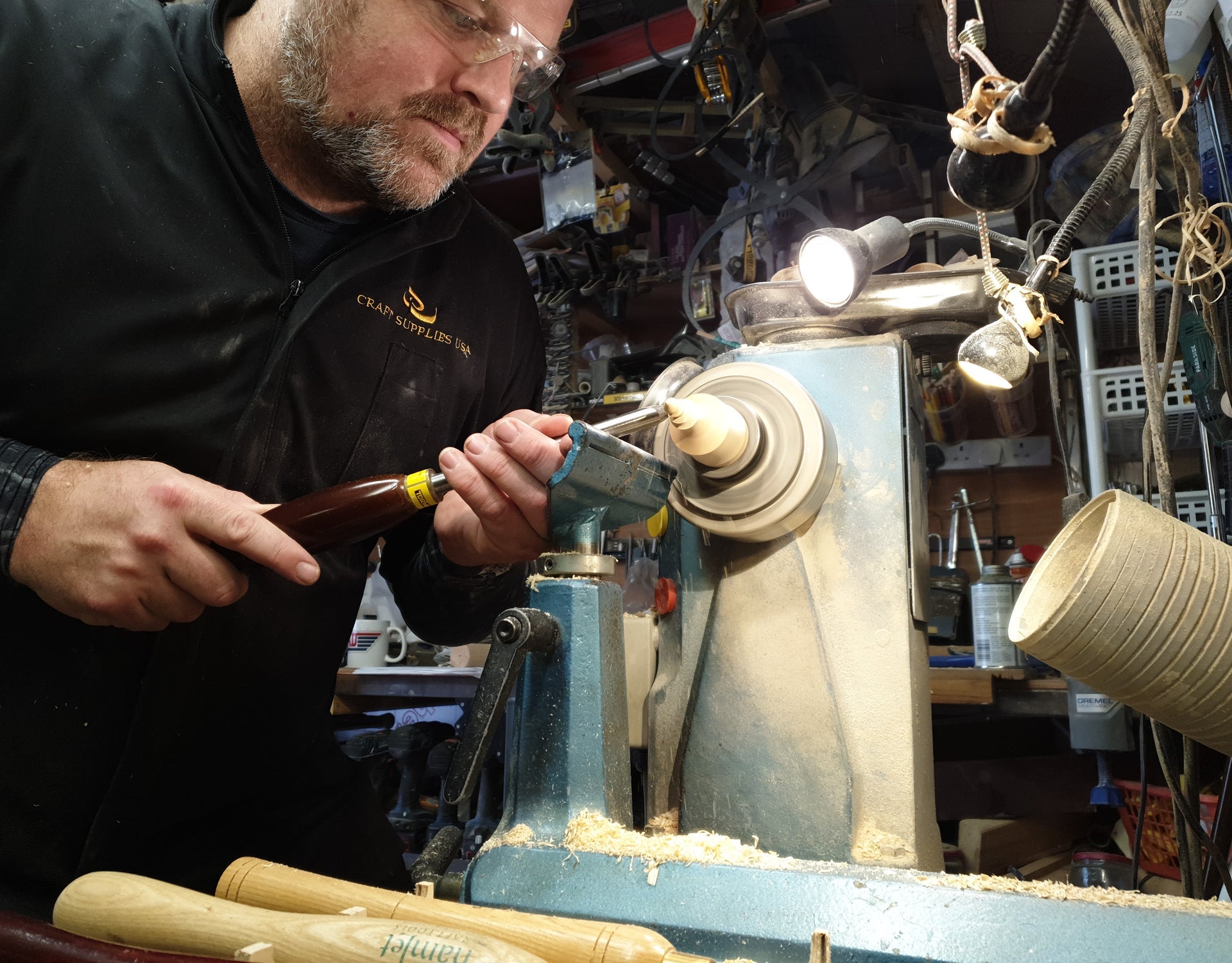 A woodturner at work with a piece of wood