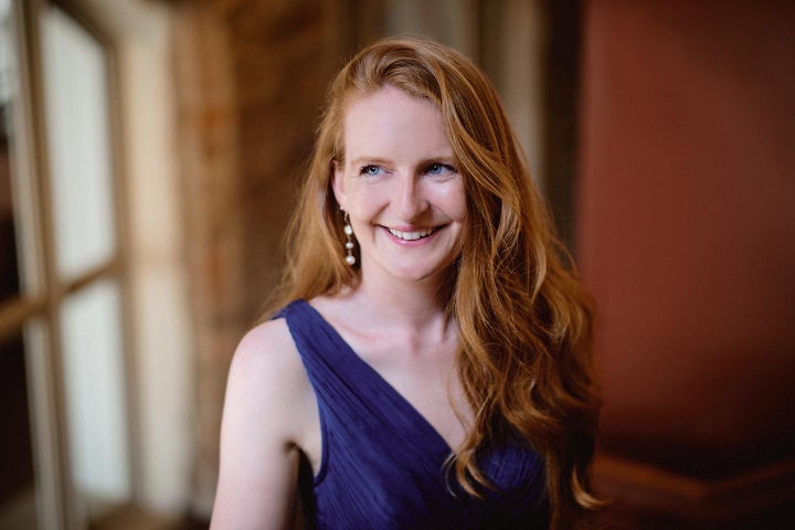 Aisling Kenny, soprano - a smiling woman with long hair in evening dress