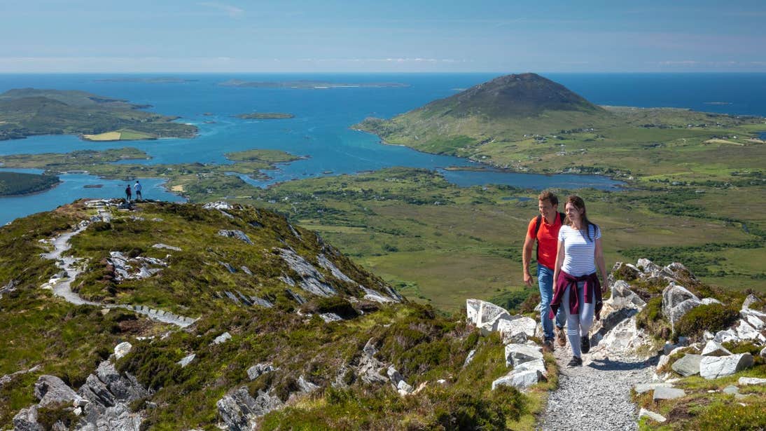 Two groups of people hiking to the lookout point on Diamond Hill Loop, County Galway