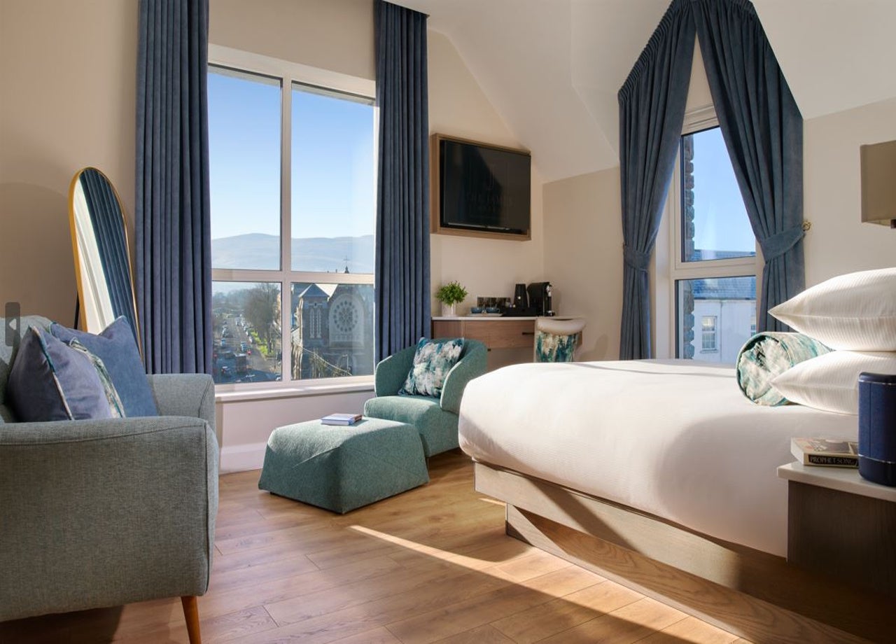 Suite with seating area and bed