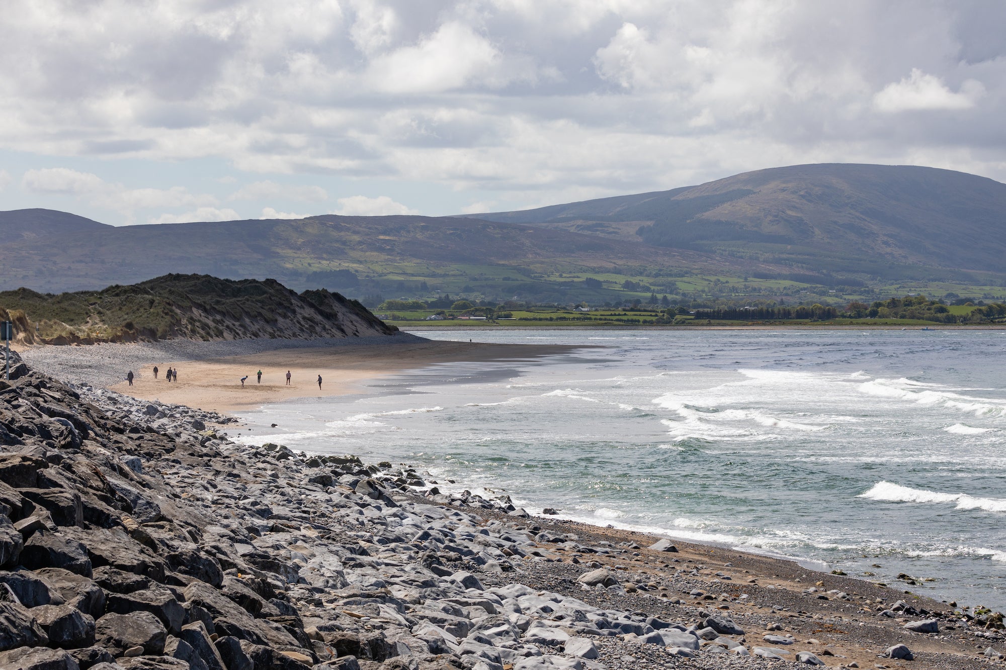 People walking on Strandhill Beach in County Sligo.