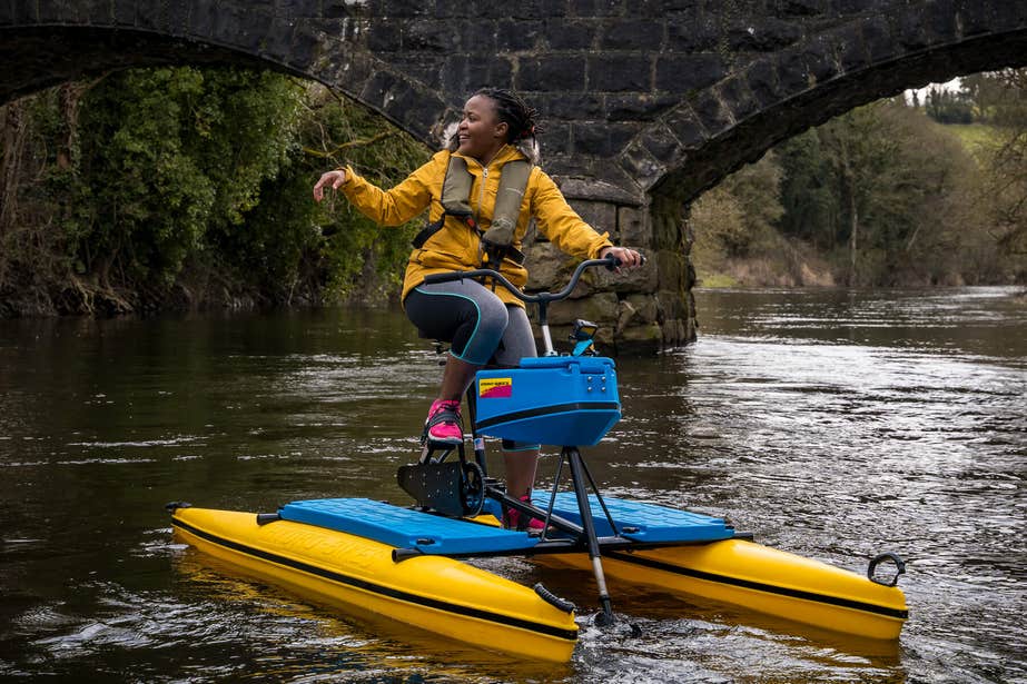Young woman riding a Hydrobike on Carafin Lake.