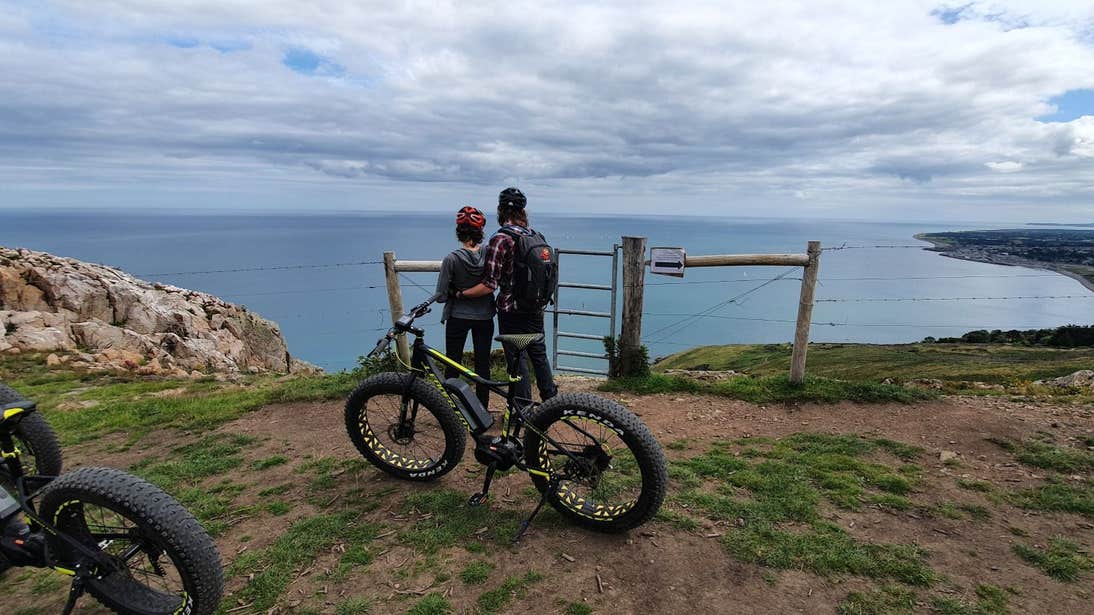 Two cyclists pausing to admire the view together at Bray Head, Co. Wicklow