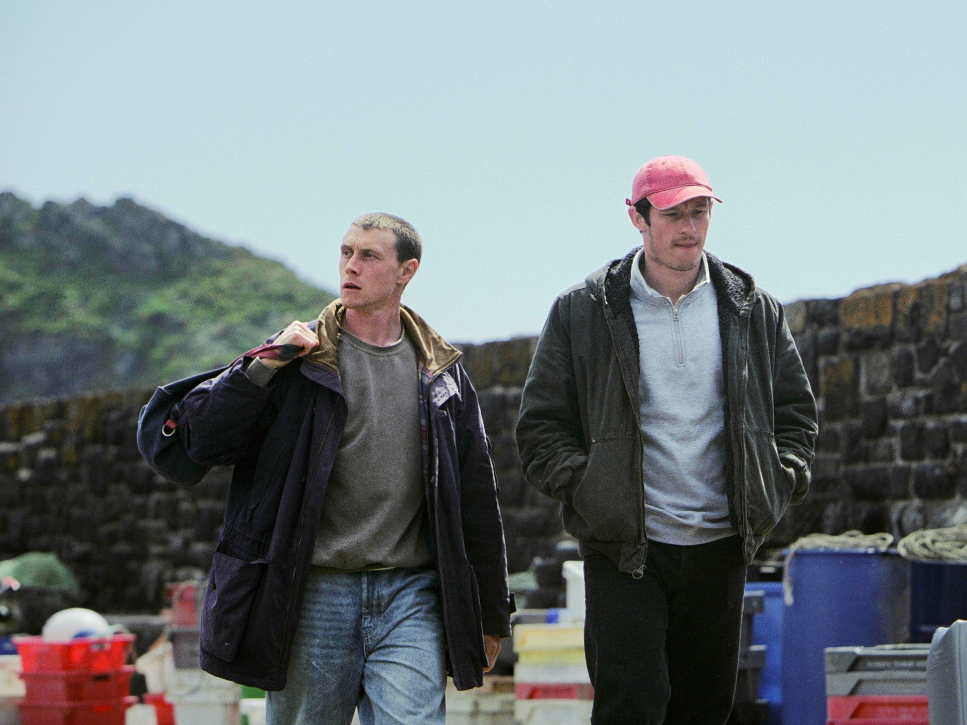 Two men walking along a dock.