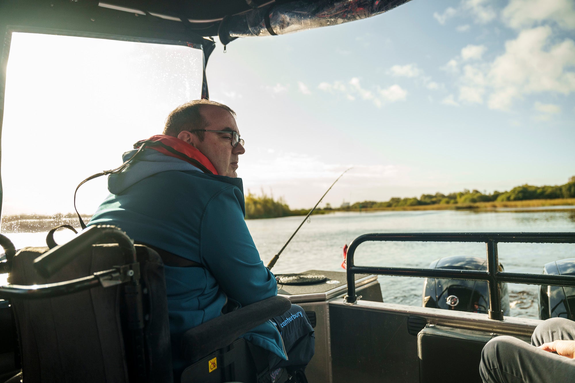A man in a wheelchair fishing on a boat in Lough Ree in County Roscommon.