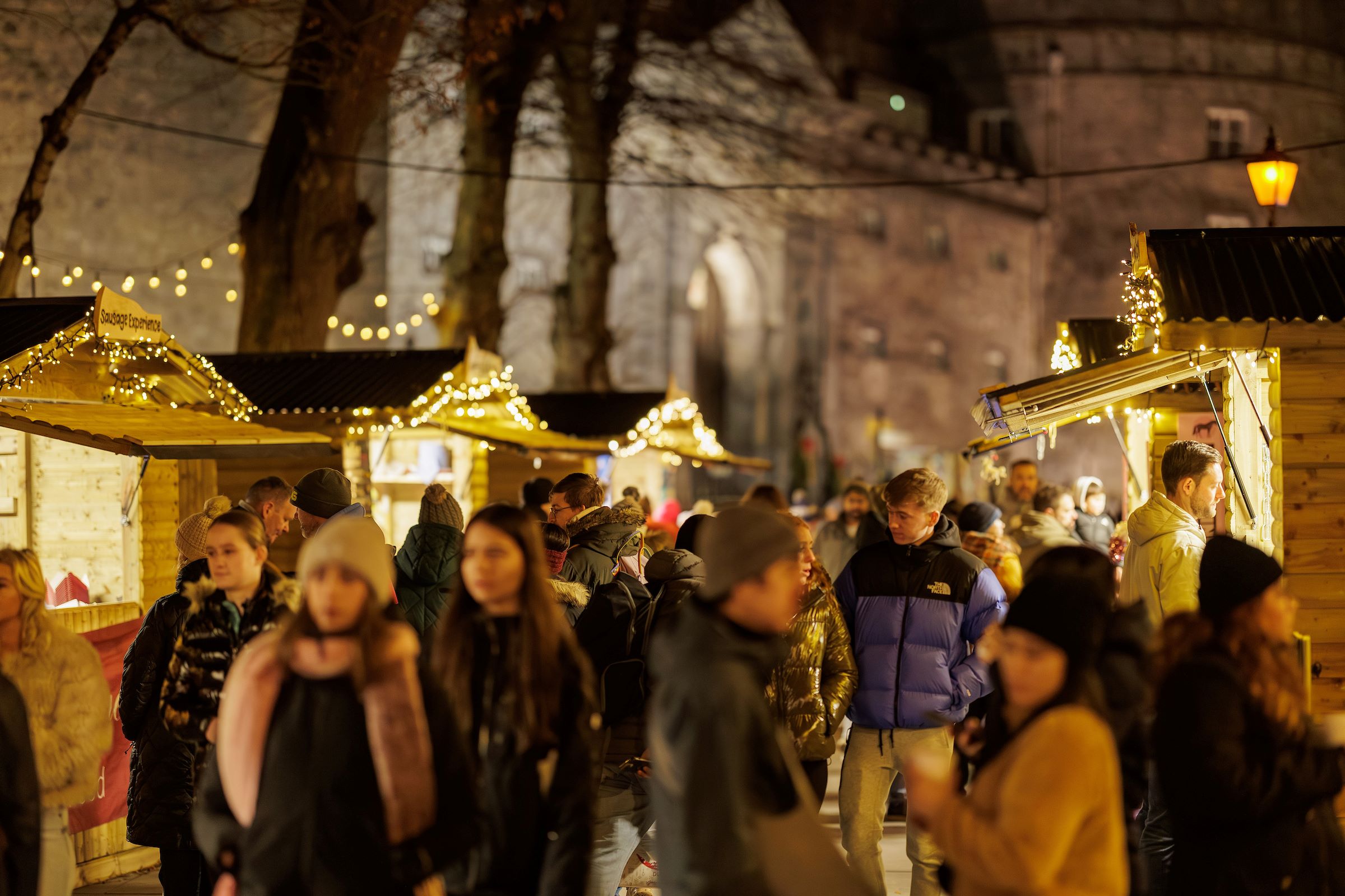 Twinkling Christmas Chalets sell festive goods overlooked by Kilkenny Castle