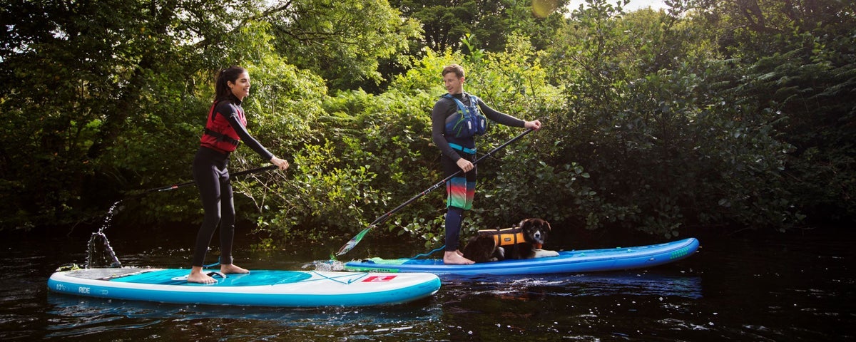 Two people stand up paddle boarding