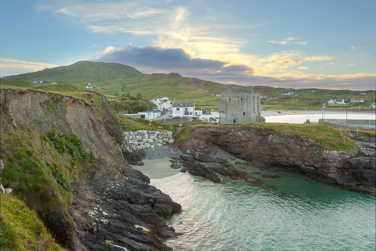 Cliffs and sea with a castle and beach behind