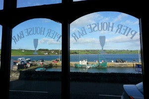 Photo looking out at the pier through the bar window.
