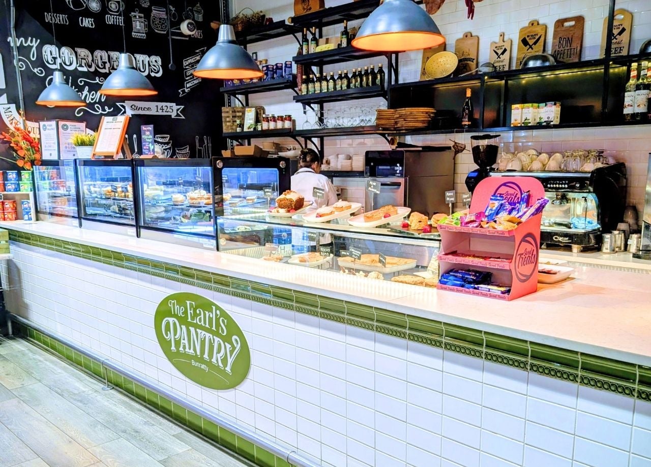 A café counter showcasing a variety of pastries and cakes