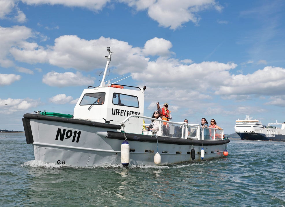 The Old Liffey Ferry number eleven on the water with people waving