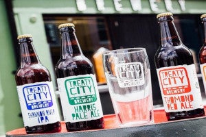 Bottles of beer beside a glass outside Treaty City Brewery in Limerick city.