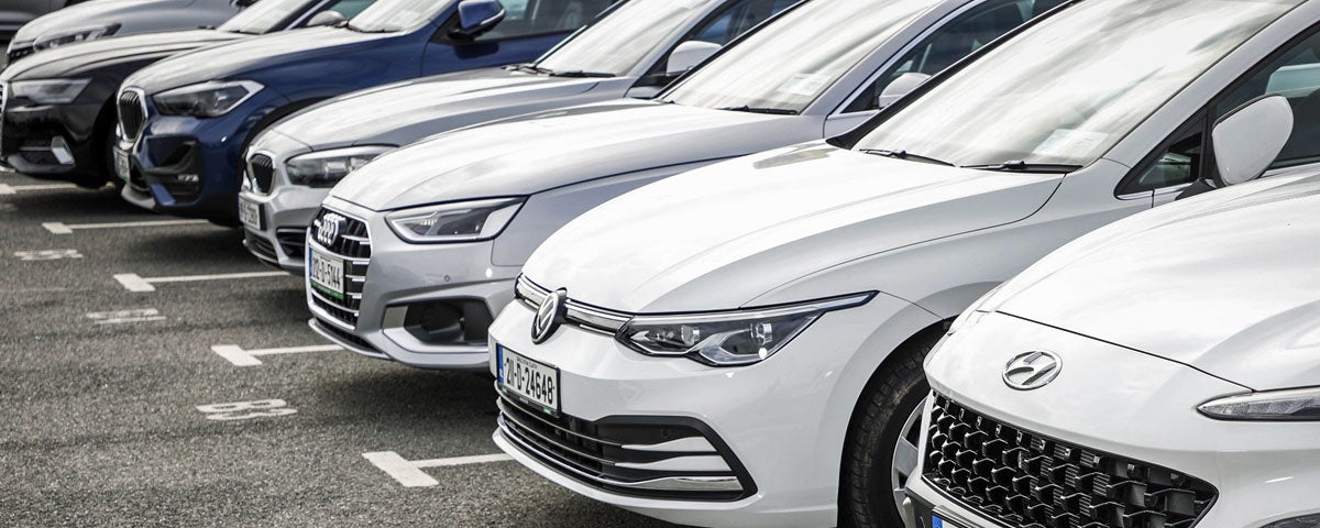 Rental cars parked in a row awaiting collection