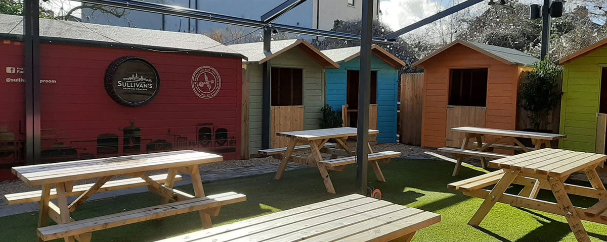 Empty benches in an outside dining area at a pub