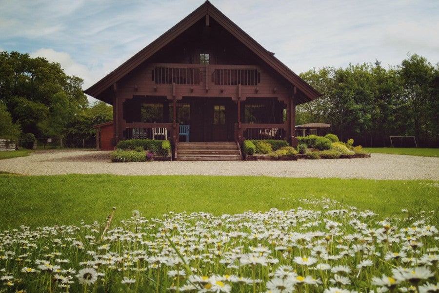 Garden with flowers and cabin in the background