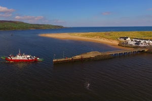Image of ferry arriving at island port.