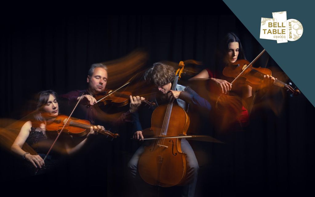 Dark photo with 4 people playing string instruments