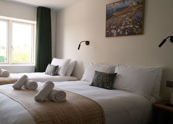 Double and single beds with white sheets