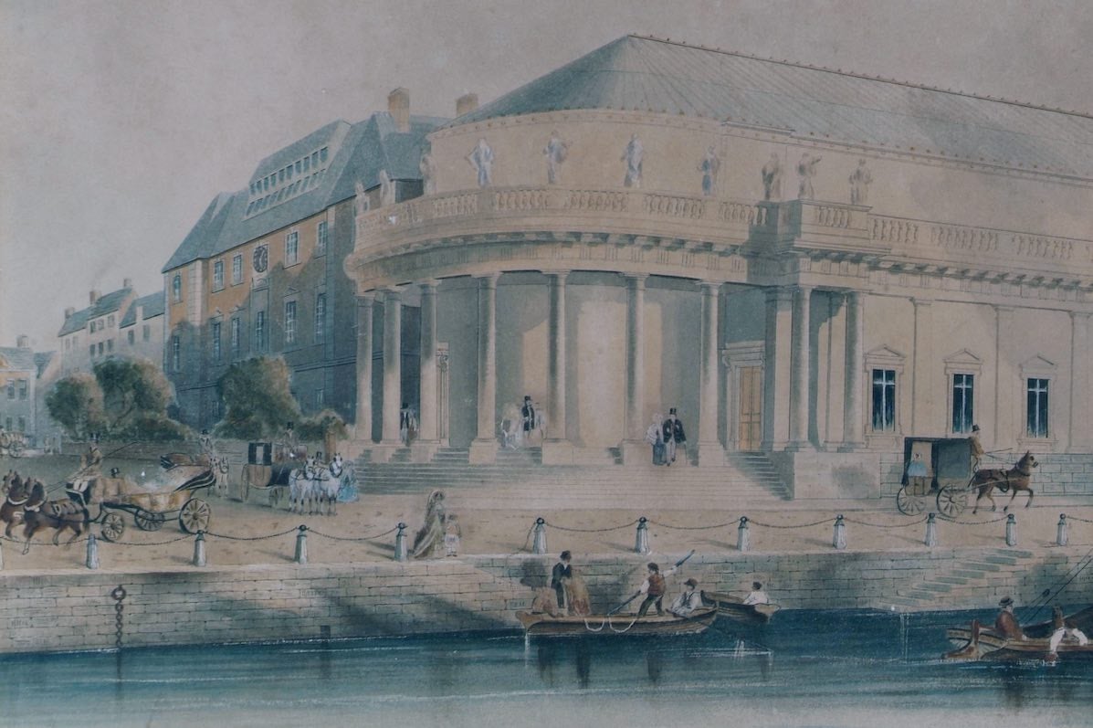 An old drawing showing the Crawford Art Gallery in a previous century with water and a dock outside and horses and carriages.