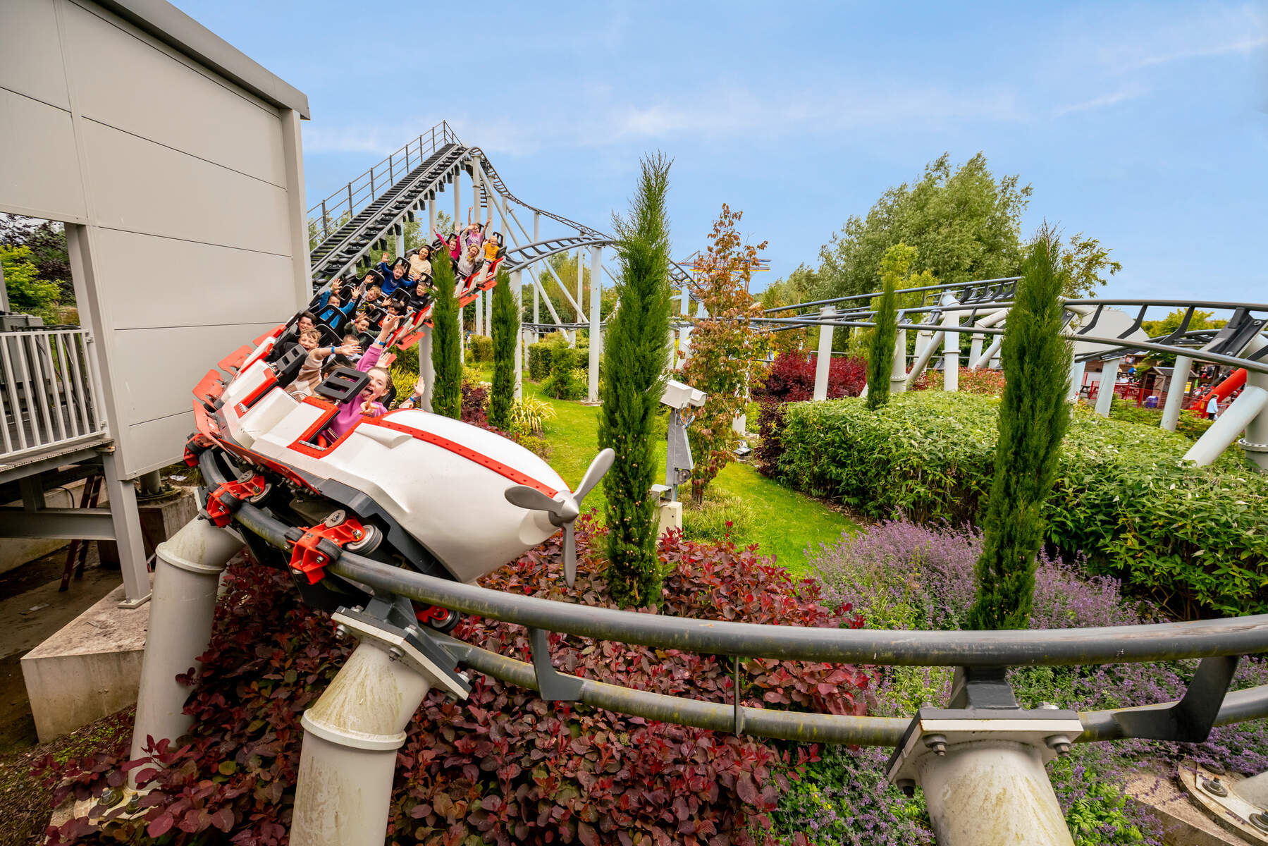 Roller coaster winding around Emerald Park.