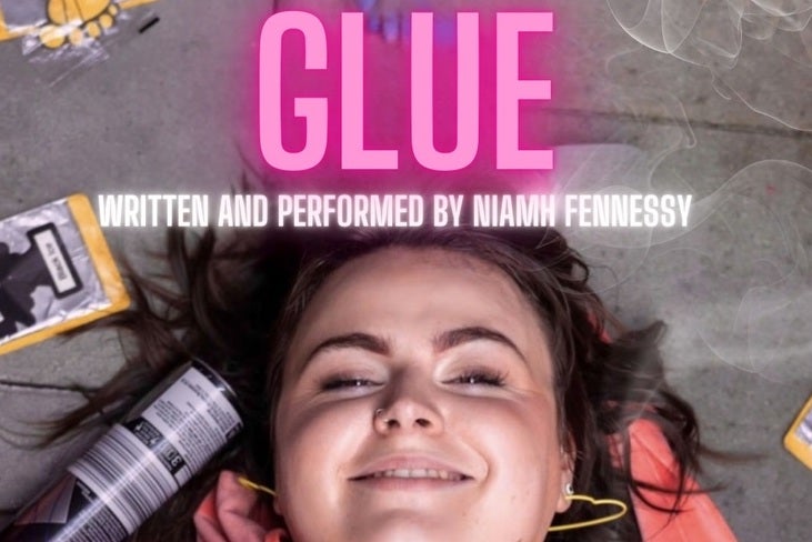 A smiling girl lying on grey floor