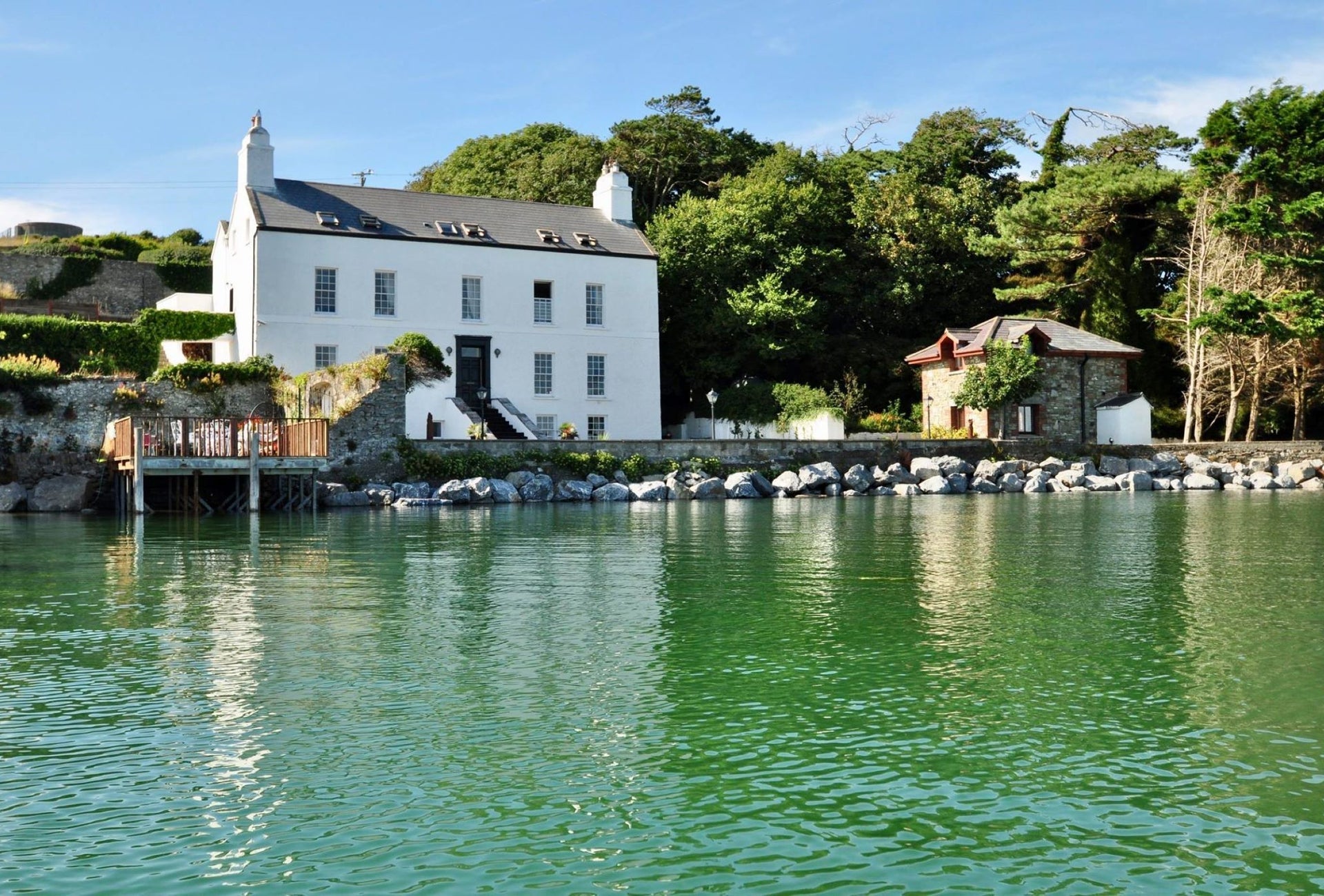 View of a large two storey building overlooking a pier