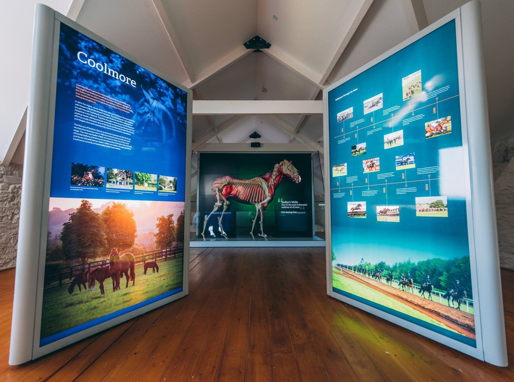 Large free standing light up display featuring text and images of horses