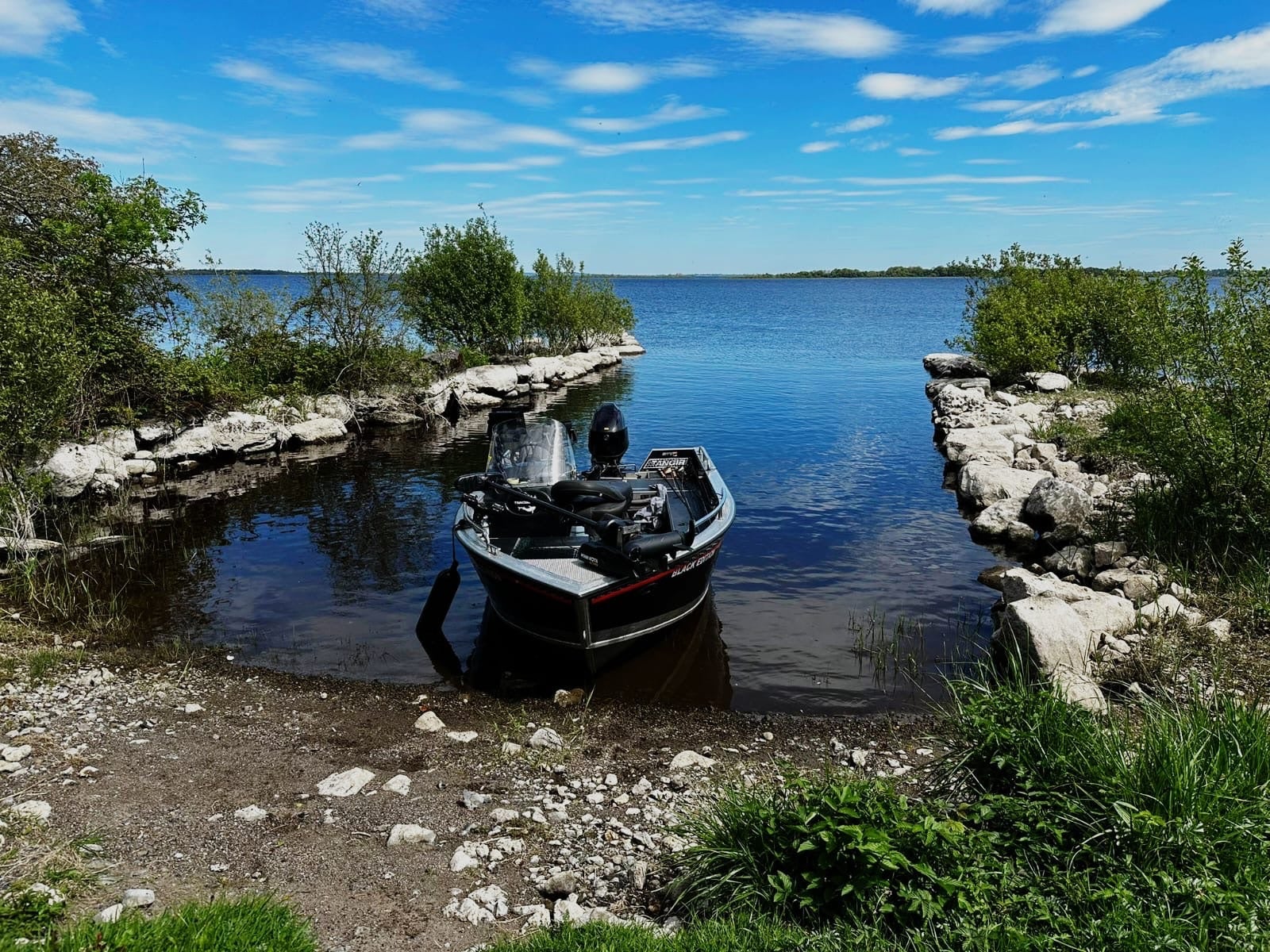 A fishing boat on the shores of Lough Ree with Brick Island Angling
