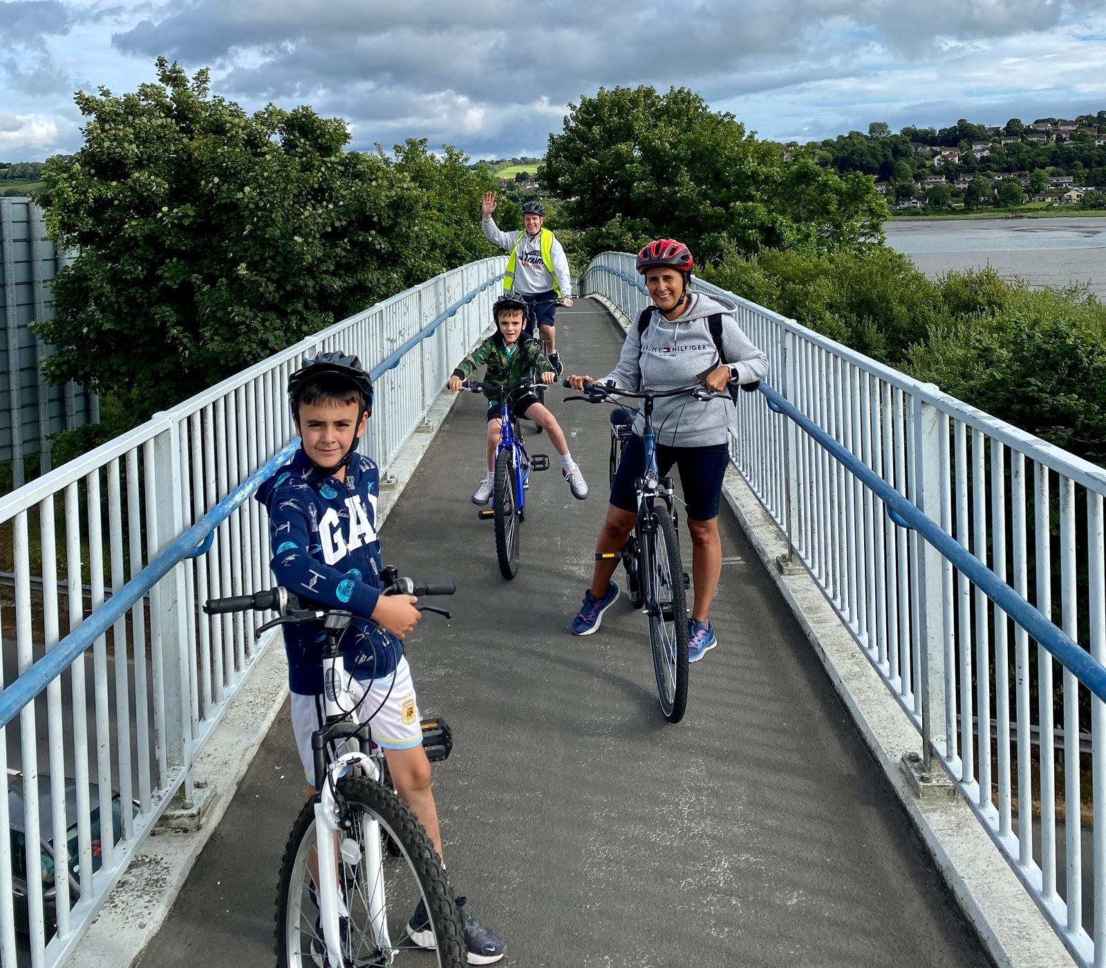 Family on a narrow bridge with their bikes