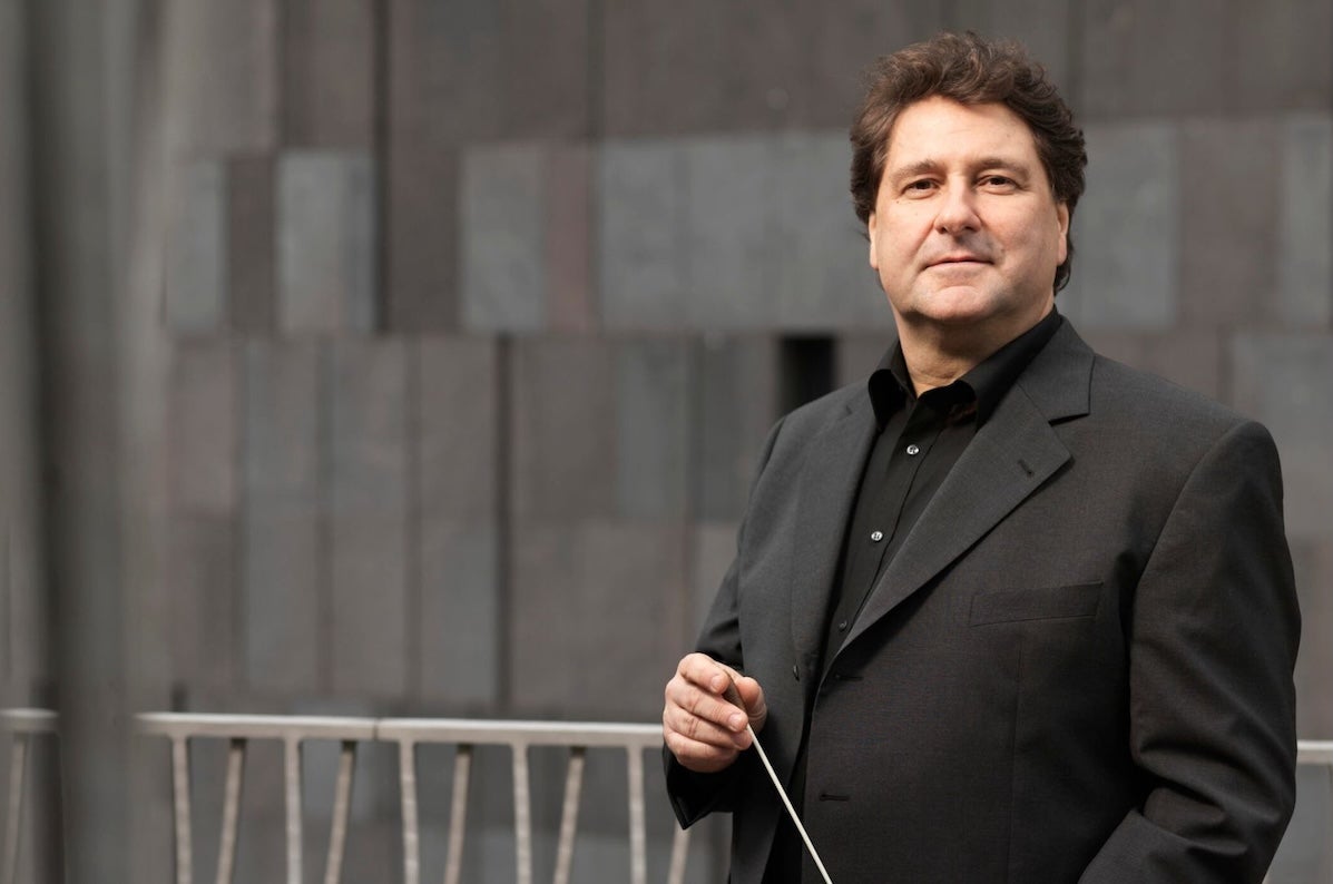 Johannes Widler, conductor - a man in dark jacket and shirt holding a baton.