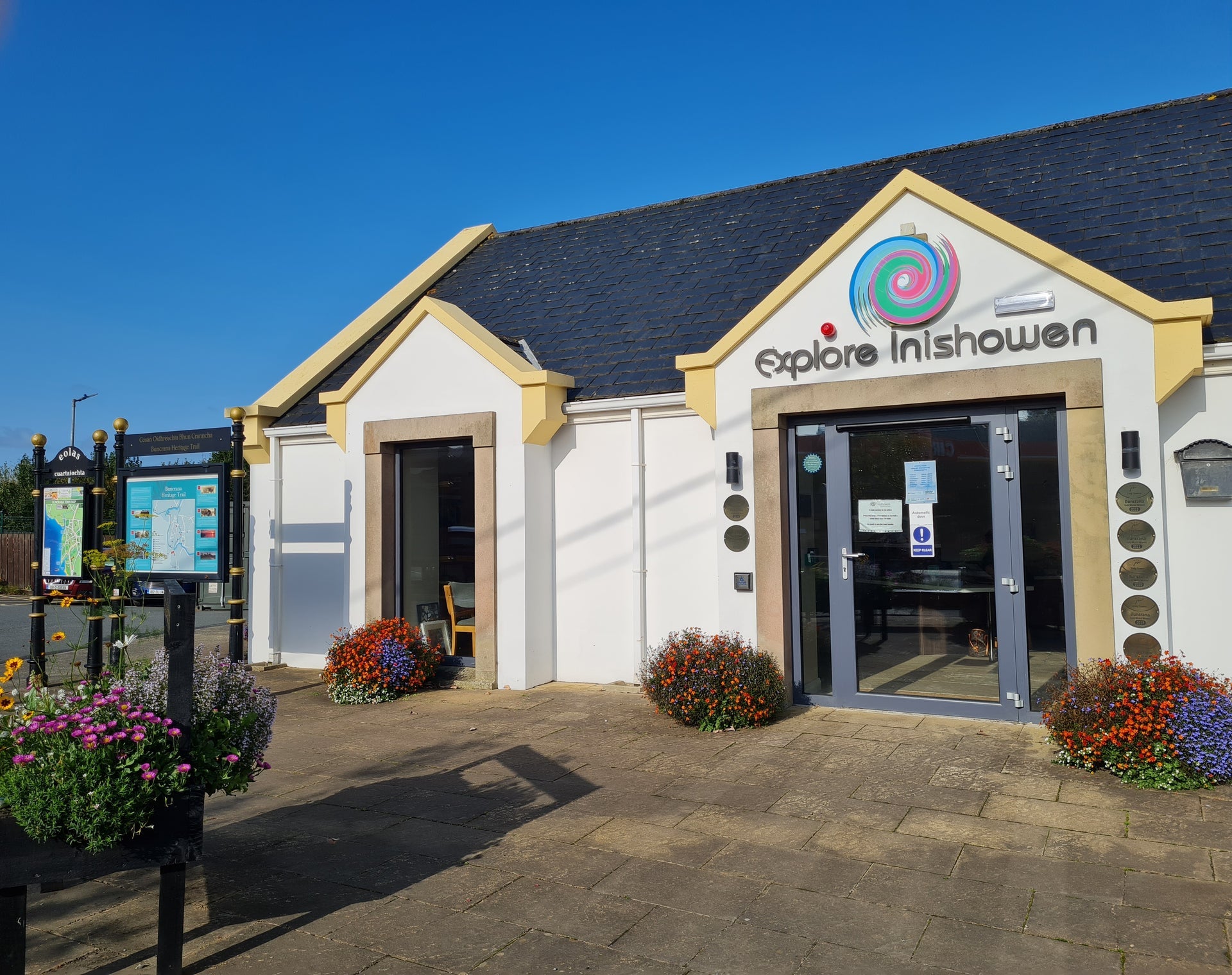 An image of the Inishowen Community Tourist Office exterior with an information board