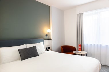 Double bed with white sheets