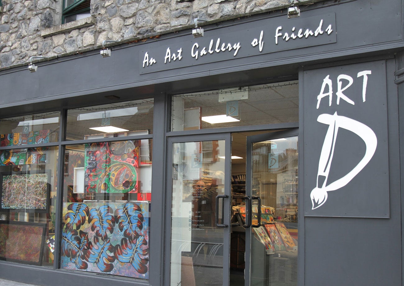 Exterior view of ArtD Gallery with art on display in the window
