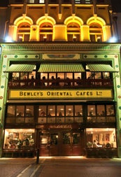 Exterior of a three storey city building with a business sign