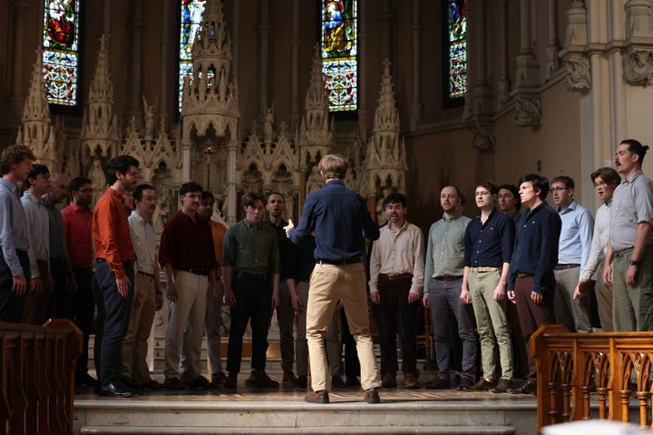 A group of men singing in a churc