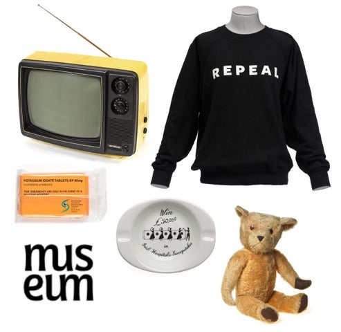 A group of random items against a white background including a teddy bear, a ashtray and an old portable TV