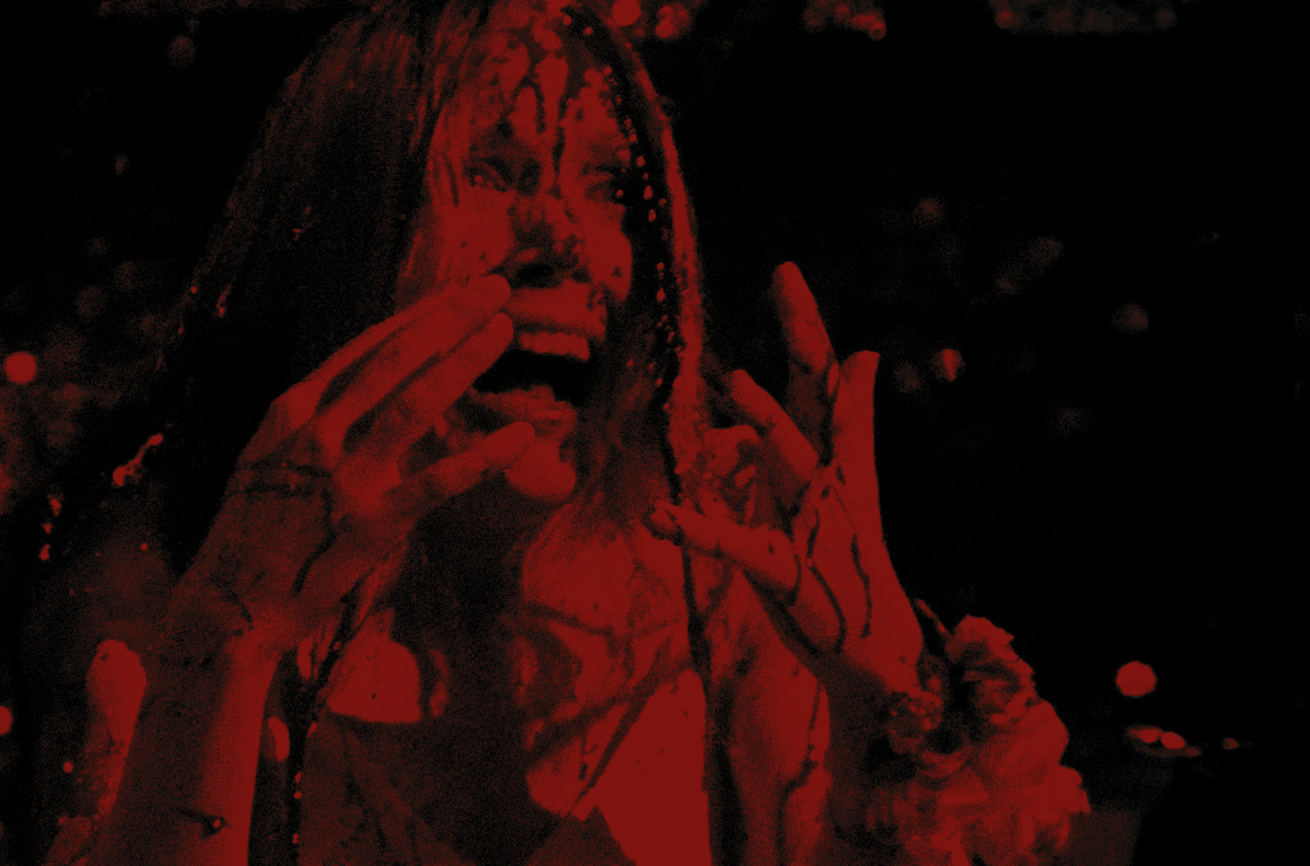 A dark figure in red is screaming with hands held up to their face.