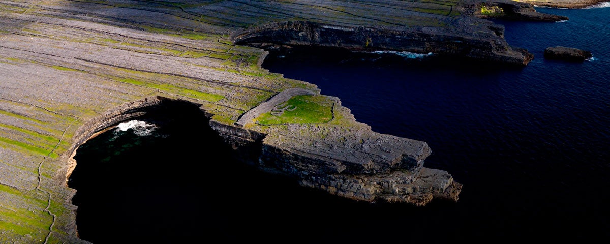 Aerial view of Dun Ducathair Fort on cliff edge of Inishmore Aran Islands