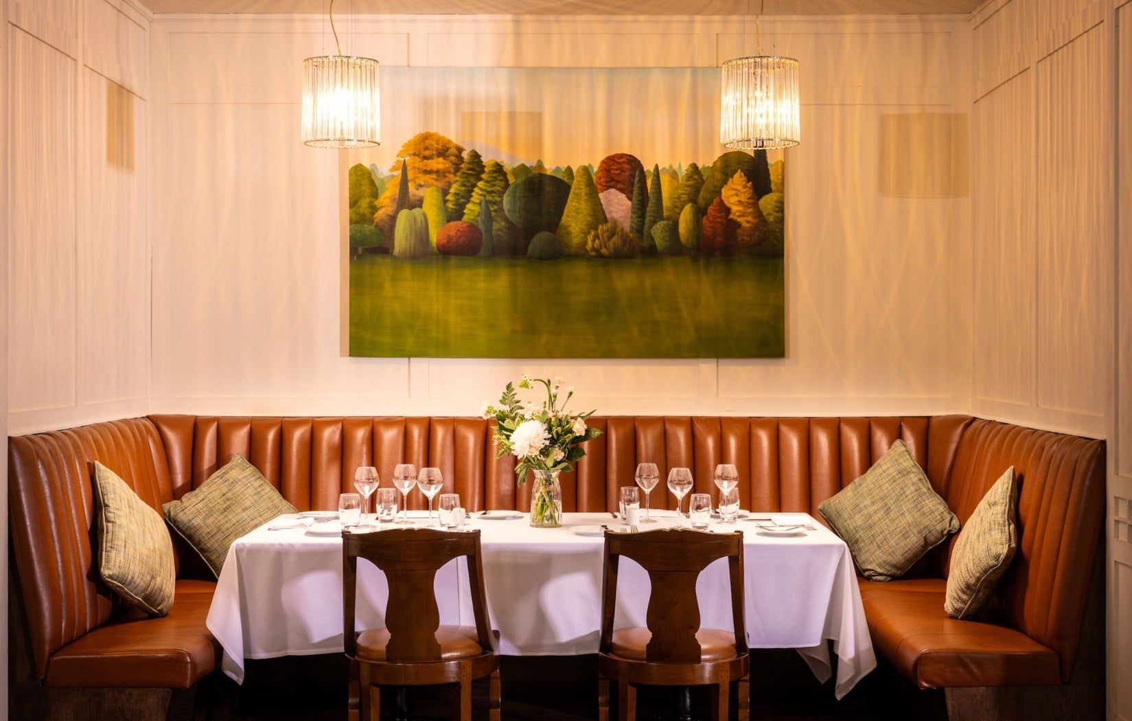 Leather corner seating area with a table prepared for dining