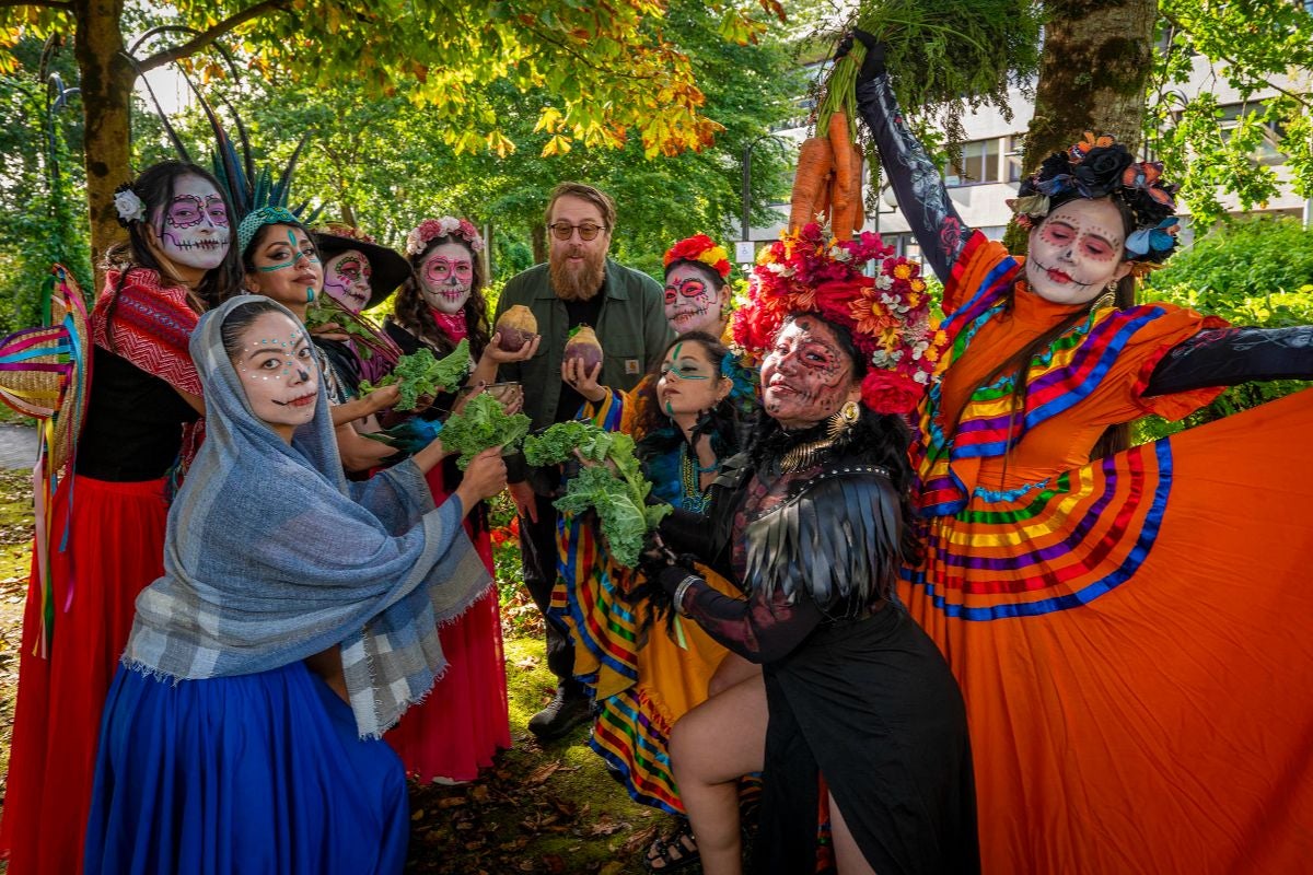 Traditional Catrina makeup, colorful costumes, dancing, and live music
