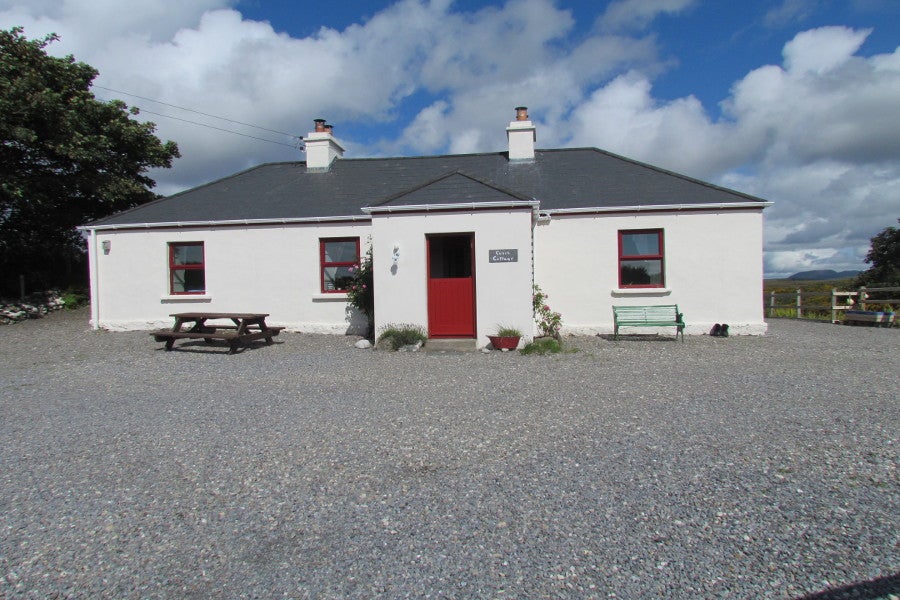White cottage with red door