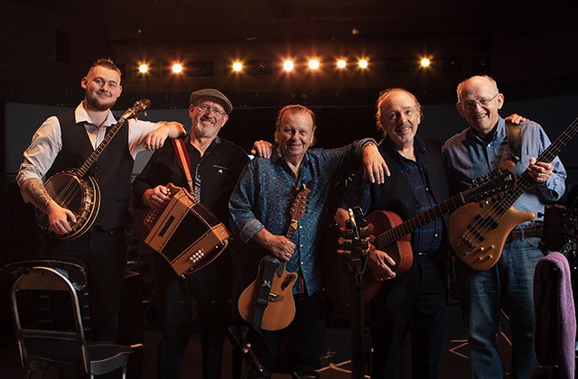 The Fureys, Farewell Tour. 5 smiling men in a line, resting on each others shoulders, holding various musical instruments.